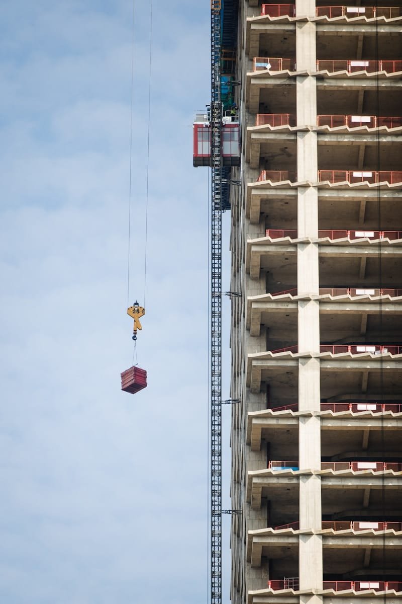 a crane is attached to the side of a tall building
