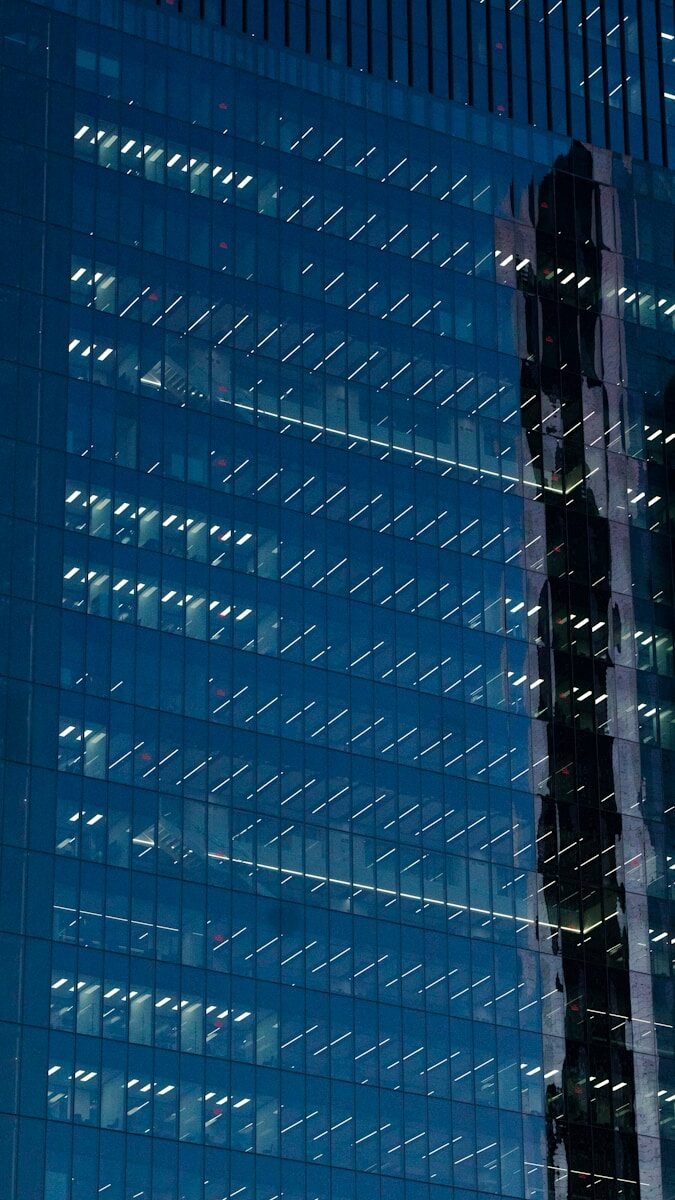 Photo by Pablo de la Fuente a very tall building with a lot of windows