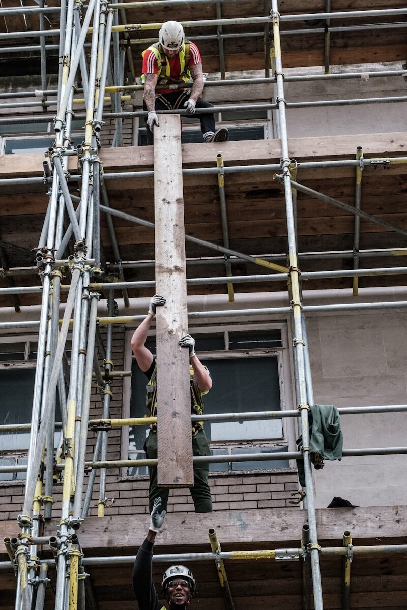 Photo by Kevin Grieve man in black shorts on brown metal ladder